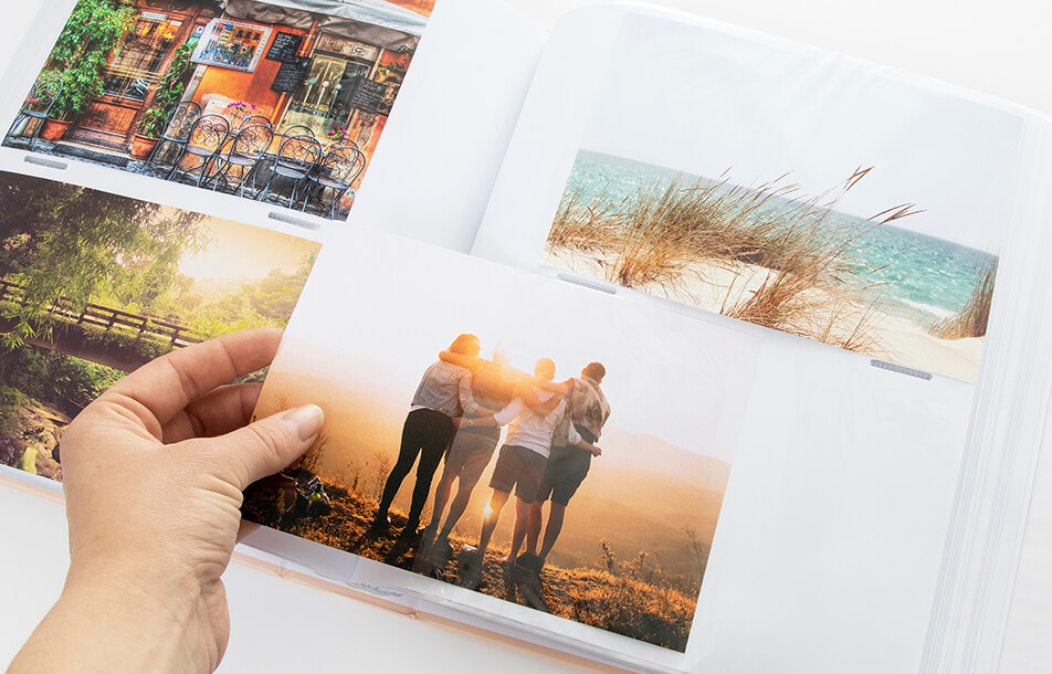 Odprt fotoalbum s plastičnimi žepi in fotografijami